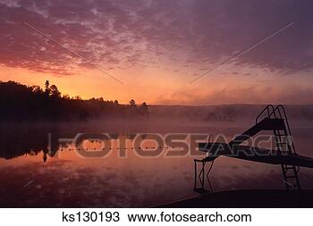 Stock Photo - sunrise on oxtongue 
lake dwight (haliburton), 
ontario, canada. 
fotosearch - search 
stock photos, 
pictures, images, 
and photo clipart