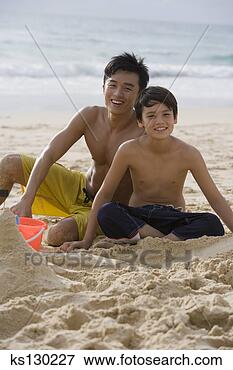 Picture - two people playing 
in the sand. fotosearch 
- search stock 
photos, pictures, 
images, and photo 
clipart