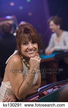 Stock Photography - woman sitting 
at a betting table. 
fotosearch - search 
stock photos, 
pictures, images, 
and photo clipart