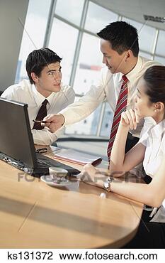 Stock Photo - businessman pointing 
at laptop for 
colleagues. fotosearch 
- search stock 
photos, pictures, 
images, and photo 
clipart