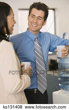 Stock Photo - businesspeople 
conversing by 
water cooler. 
fotosearch - search 
stock photos, 
pictures, images, 
and photo clipart