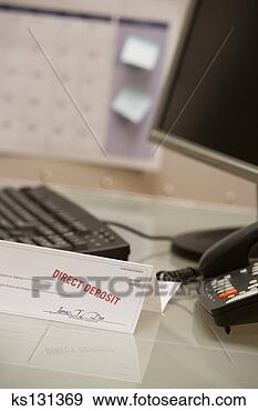 Stock Photograph - paycheck on desk 
stamped for direct 
deposit. fotosearch 
- search stock 
photos, pictures, 
images, and photo 
clipart