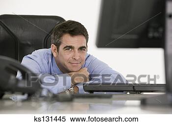 Stock Image - relaxed businessman 
at desk. fotosearch 
- search stock 
photos, pictures, 
images, and photo 
clipart