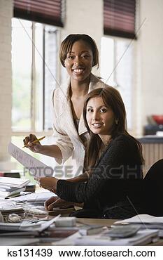 Stock Photograph - smiling businesswomen 
working. fotosearch 
- search stock 
photos, pictures, 
images, and photo 
clipart