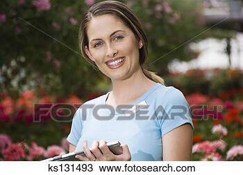 Stock Photo - smiling woman 
working at garden 
center. fotosearch 
- search stock 
photos, pictures, 
images, and photo 
clipart