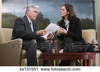 Stock Photography - businesspeople 
discussing paperwork. 
fotosearch - search 
stock photos, 
pictures, images, 
and photo clipart