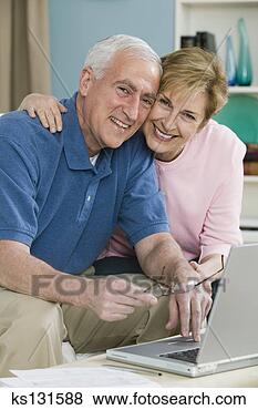 Stock Photo - happy couple using 
laptop at home. 
fotosearch - search 
stock photos, 
pictures, images, 
and photo clipart