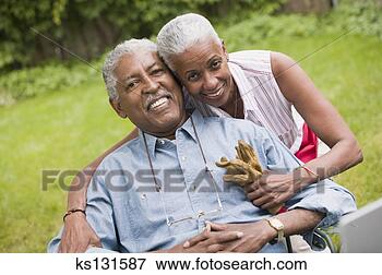 Picture - loving couple 
smiling outdoors. 
fotosearch - search 
stock photos, 
pictures, images, 
and photo clipart
