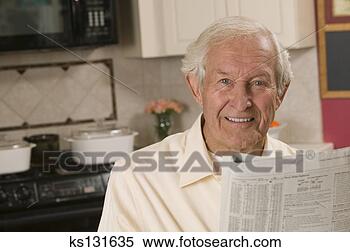 Stock Image - smiling man reading 
newspaper at home. 
fotosearch - search 
stock photos, 
pictures, images, 
and photo clipart