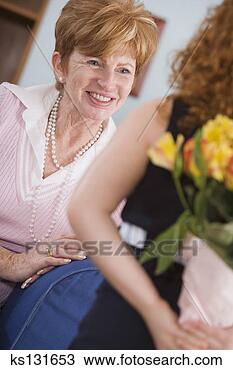 Stock Photo - smiling woman 
about to receive 
flowers. fotosearch 
- search stock 
photos, pictures, 
images, and photo 
clipart