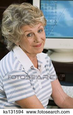 Stock Photo - smiling woman 
at computer. fotosearch 
- search stock 
photos, pictures, 
images, and photo 
clipart