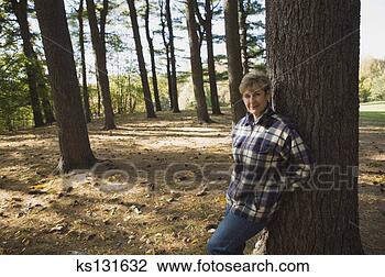 Stock Photo - smiling woman 
standing in woods. 
fotosearch - search 
stock photos, 
pictures, images, 
and photo clipart