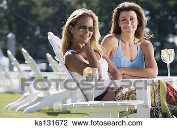 Stock Photo - friends relaxing 
outdoors with 
drinks. fotosearch 
- search stock 
photos, pictures, 
images, and photo 
clipart