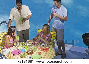 Stock Photography - friends relaxing 
at poolside. fotosearch 
- search stock 
photos, pictures, 
images, and photo 
clipart