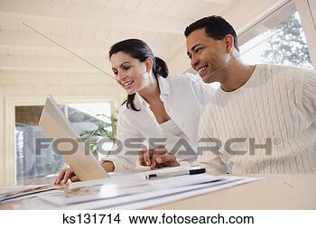 Stock Photo - smiling couple 
using laptop together. 
fotosearch - search 
stock photos, 
pictures, images, 
and photo clipart