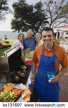 Picture - smiling man grilling 
food. fotosearch 
- search stock 
photos, pictures, 
images, and photo 
clipart