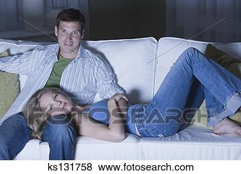 Stock Photo - couple watching 
tv on couch. fotosearch 
- search stock 
photos, pictures, 
images, and photo 
clipart