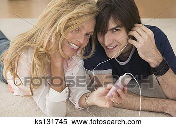 Stock Image - man and woman 
lying on floor 
listening to music. 
fotosearch - search 
stock photos, 
pictures, images, 
and photo clipart
