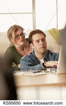 Stock Photography - couple working 
with laptop. fotosearch 
- search stock 
photos, pictures, 
images, and photo 
clipart