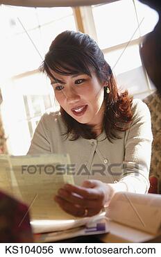 Stock Photo - woman looking 
at paperwork. 
fotosearch - search 
stock photos, 
pictures, images, 
and photo clipart