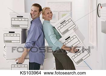 Stock Photo - business team 
moving boxes, 
portrait. fotosearch 
- search stock 
photos, pictures, 
images, and photo 
clipart