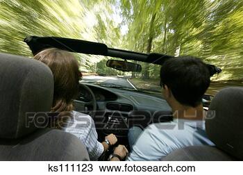 Stock Photo - couple driving 
down a road. fotosearch 
- search stock 
photos, pictures, 
images, and photo 
clipart