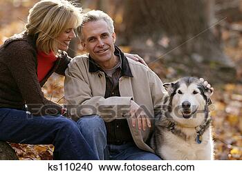Stock Photography - man and woman 
with dog outside, 
portrait. fotosearch 
- search stock 
photos, pictures, 
images, and photo 
clipart