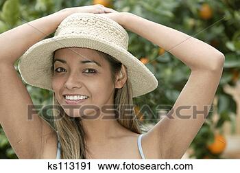 Stock Photography - woman outside 
with orange trees 
in background, 
portrait. fotosearch 
- search stock 
photos, pictures, 
images, and photo 
clipart