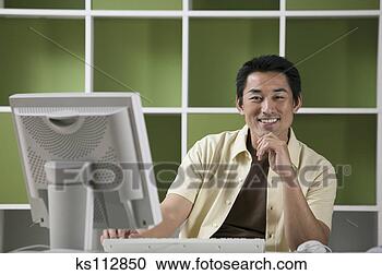 Stock Photography - man sitting with 
desktop computer, 
portrait. fotosearch 
- search stock 
photos, pictures, 
images, and photo 
clipart