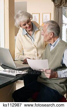 Picture - elderly couple 
using laptop computer. 
fotosearch - search 
stock photos, 
pictures, images, 
and photo clipart