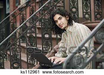 Stock Photography - man sitting outside 
on steps using 
laptop computer, 
portrait. fotosearch 
- search stock 
photos, pictures, 
images, and photo 
clipart