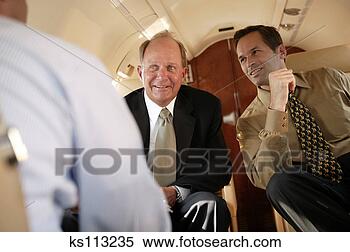 Stock Image - businessmen talking 
in private plane. 
fotosearch - search 
stock photos, 
pictures, images, 
and photo clipart