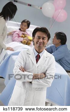 Stock Photograph - portrait of a 
doctor, parents 
tending to sick 
child in background. 
fotosearch - search 
stock photos, 
pictures, images, 
and photo clipart