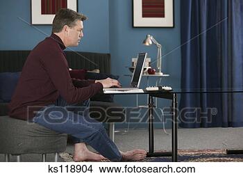 Stock Photo - man using laptop 
computer. fotosearch 
- search stock 
photos, pictures, 
images, and photo 
clipart