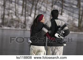 Stock Photo - couple with ice 
skates, rear view. 
fotosearch - search 
stock photos, 
pictures, images, 
and photo clipart