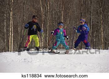 Stock Photo - three children 
skiing. fotosearch 
- search stock 
photos, pictures, 
images, and photo 
clipart