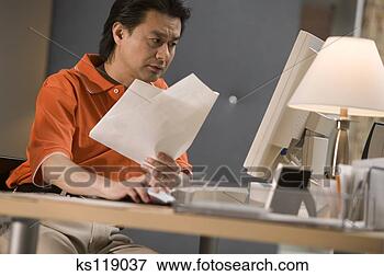 Picture - business man using 
computer and doing 
paperwork. fotosearch 
- search stock 
photos, pictures, 
images, and photo 
clipart