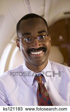 Stock Photo - businessman traveling 
on airplane, portrait. 
fotosearch - search 
stock photos, 
pictures, images, 
and photo clipart