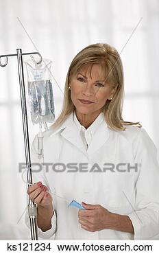 Stock Photo - medical professional 
adjusting iv, 
portrait. fotosearch 
- search stock 
photos, pictures, 
images, and photo 
clipart