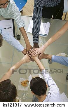 Picture - business people 
putting their 
hands together, 
shot from above. 
fotosearch - search 
stock photos, 
pictures, images, 
and photo clipart