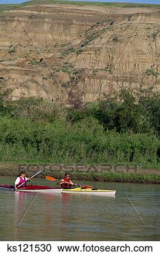 Stock Photography - couple sea-kayaking 
on red deer river, 
 dinosaur provincial 
park. fotosearch 
- search stock 
photos, pictures, 
images, and photo 
clipart