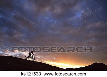Stock Photo - man mountain-biking 
on slickrock at 
dawn moab, utah, 
usa. fotosearch 
- search stock 
photos, pictures, 
images, and photo 
clipart