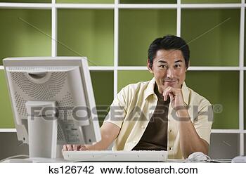 Stock Photo - man using computer. 
fotosearch - search 
stock photos, 
pictures, images, 
and photo clipart