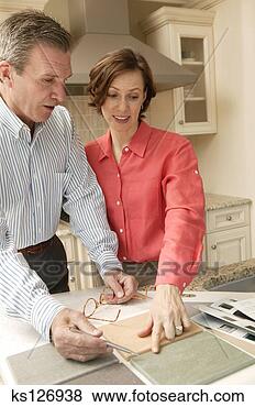 Stock Photo - couple comparing 
kitchen tiling. 
fotosearch - search 
stock photos, 
pictures, images, 
and photo clipart
