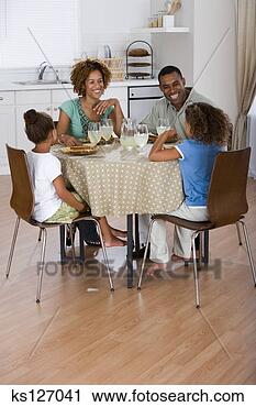 Stock Photography - family eating 
at kitchen table 
together. fotosearch 
- search stock 
photos, pictures, 
images, and photo 
clipart