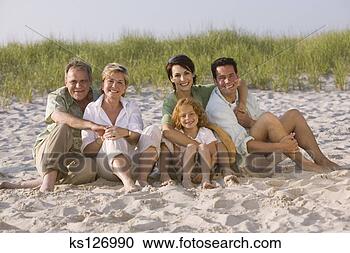 Stock Photography - family sitting 
on beach. fotosearch 
- search stock 
photos, pictures, 
images, and photo 
clipart