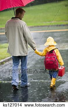 Stock Photo - father walking 
child to school 
in rain. fotosearch 
- search stock 
photos, pictures, 
images, and photo 
clipart