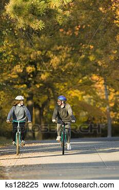 Stock Image - couple riding 
bikes in autumn. 
fotosearch - search 
stock photos, 
pictures, images, 
and photo clipart