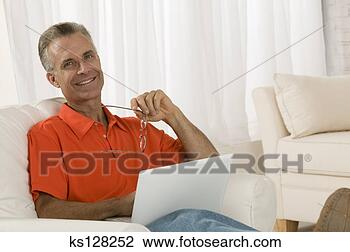 Stock Photo - man relaxing with 
laptop. fotosearch 
- search stock 
photos, pictures, 
images, and photo 
clipart