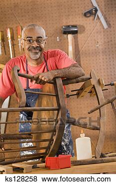 Stock Photo - man repairing 
rocking chair. 
fotosearch - search 
stock photos, 
pictures, images, 
and photo clipart